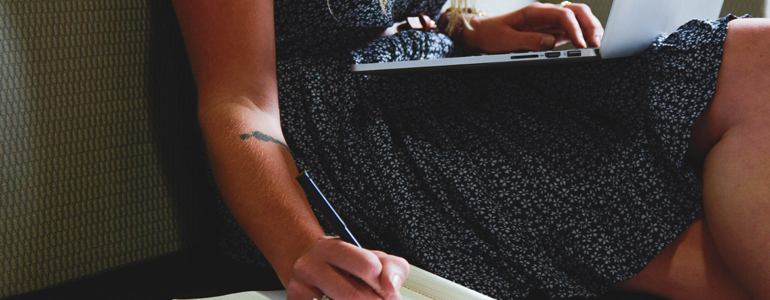 Woman Writing with Laptop