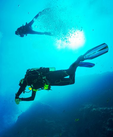 Scuba diver exploring coral reef